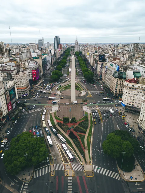 An aerial view of the Obelisco and the broad avenues of central Buenos Aires.