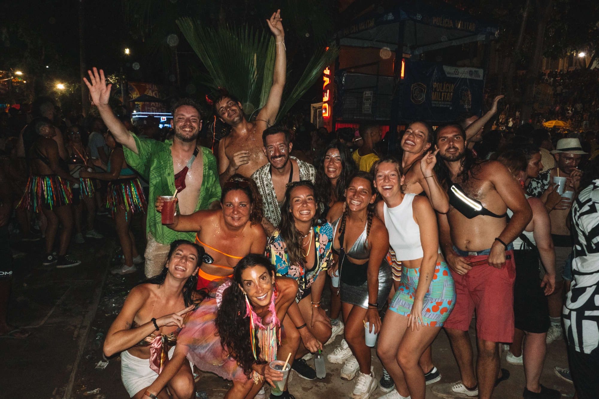 A large group of Casa Basilico guests in costumes cheering together at Carnival