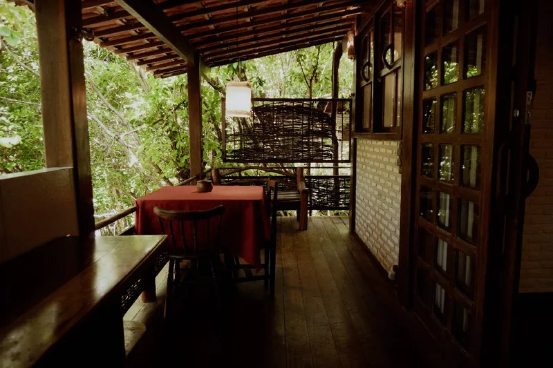 Covered Comfort Chalet patio with a table, chairs and a hammock